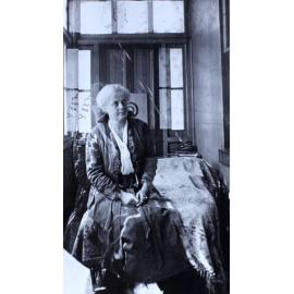 Woman sitting on the end of a day bed