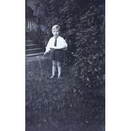 Young boy standing on the grass
