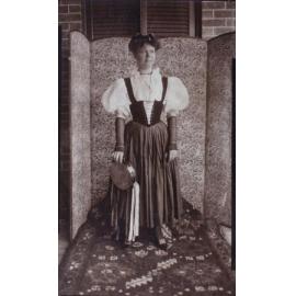Woman in fancy dress carrying a tambourine
