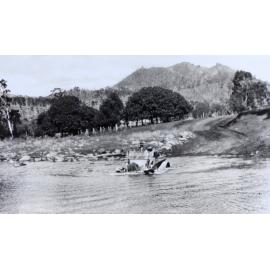 Driving a car through a flooded creek crossing