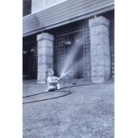 Jill playing with a water hose on the lawn