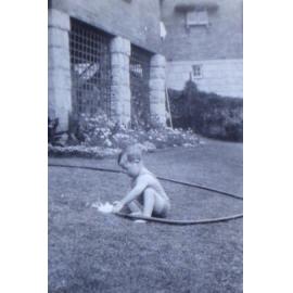 Jill playing with a water hose on the lawn