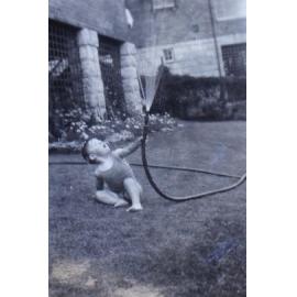 Jill playing with a water hose on the lawn