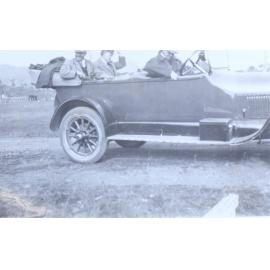 Three unidentified man sitting in a car