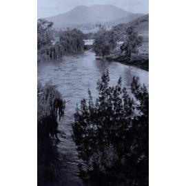 View down a river to a bridge