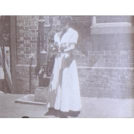 Undentified woman with four birds roosting on her arm