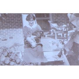 Unidentified woman with pet dog and cat