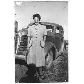 Dorothy Solomon in front of the Solomon family car, a Pontiac, early 1940s