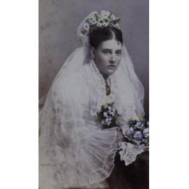 A tinted carte-de-visite of a woman in bridal dress