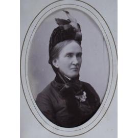 A carte-de-visite of a woman. The album page is annotated (in a modern hand) Mrs J Legh (?)