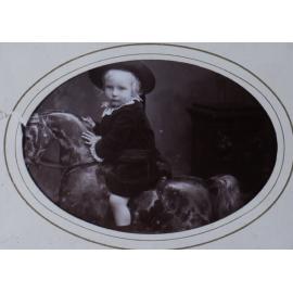 A carte-de-visite of a young child on a rocking horse
