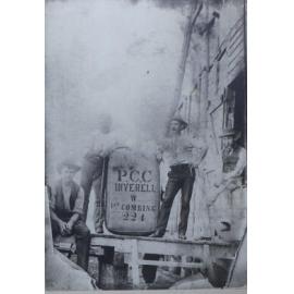 A group of men with a wool bale