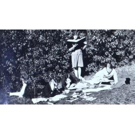 Four women studying on the lawn