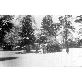 Central Park, snowman and four young men, 1917