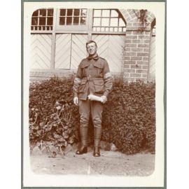 Soldier holding rolled up newspaper