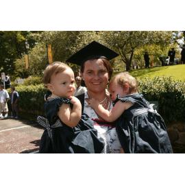 Unidentified graduate with two children, TRACKS Graduation Ceremony, UNE, 2005