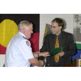 Governor of the Glenn Innes Correctional Centre, Hank Zwiers, receives award from Guido Posthausen of UNE's Oorala Centre