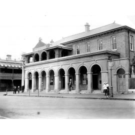 Armidale Post Office with gaslight and hitching posts, c. 1910