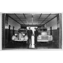 Two ambulance cars parked inside the Armidale District Station, c.1950