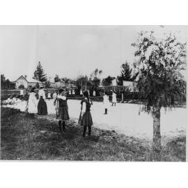 Pupils on and around tennis court at the Public School, c. 1900