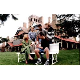 Professor Ingrid Moses with lambs and students, UNE, 1999
