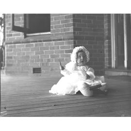 Baby sitting on a veranda