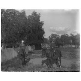 Two children riding horses