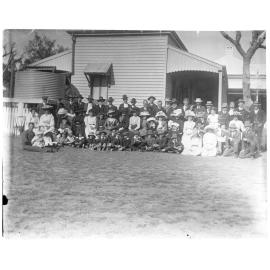Large group photo outside a house