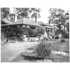 Exterior view of a house with horse and carriage
