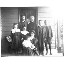 D. M. Cameron with family group on a verandah