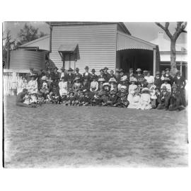 Large group portrait outside a house