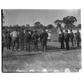 Gathered group of men, women and children