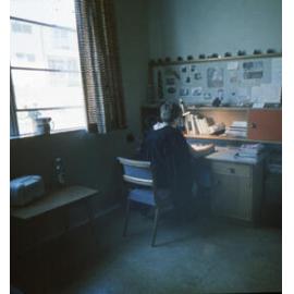 Student at desk in a Wright College room, UNE
