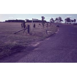 Road with signpost pointing to Wright College, UNE