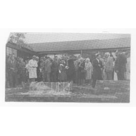 Group of unidentified people near a fountain in the [Central Courtyard, UNE]