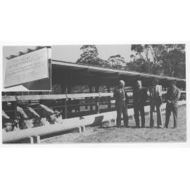 Four men standing in front of the P.A. Wright Cattle Research Facility