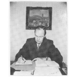 Professor Lazenby signing documents