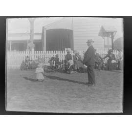 Child on a lead, at an outdoor gathering