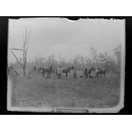 Four men, four horses, two wagons, two dogs in the bushland, 1905