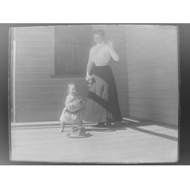 Woman and child playing on a verandah