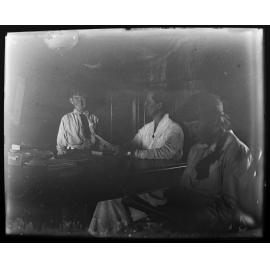 Two women and a boy at a desk with books