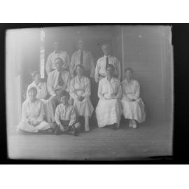 Posed group portrait of four men, four women, a girl and a boy