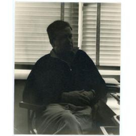 John Ryan seated at a desk