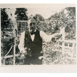 Fred Voisey holding shears in the garden