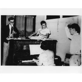 Three musicians playing piano, flute and clarinet with a conductor