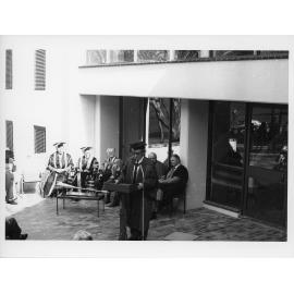 Person giving an adress at the opening of Economics