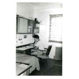 Wright College student studying in a dorm room