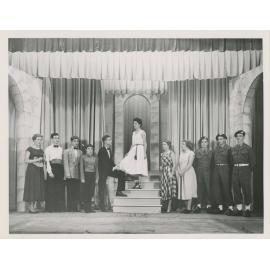 Cast of students on a theatre set