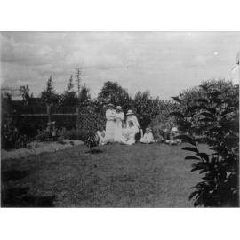 Photo of a group of women and children in a garden