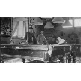 Three men playing billards